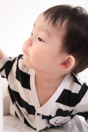 Asian baby boy in studio - isolated on whiteの写真素材