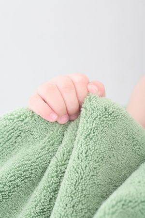 Body part of asian baby boy - isolated on whiteの写真素材