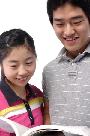 Young asian couple in studio - isolated on whiteの写真素材