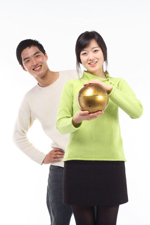 Young asian couple in studio - isolated on whiteの写真素材