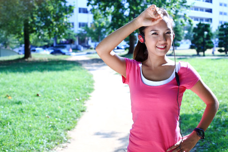 Young Asian woman doing yoga poses in the parkの写真素材