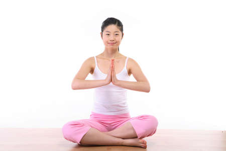 Young Asian woman doing yoga poses - isolated on whiteの写真素材