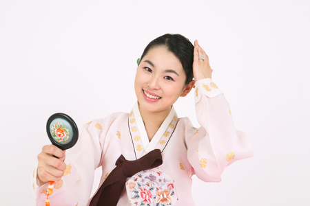 Asian woman with traditional clothing perfoming traditional play - isolated on whiteの写真素材