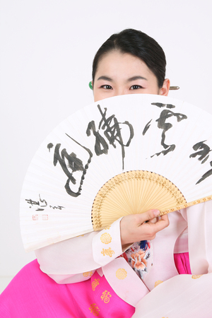 Asian woman with traditional clothing perfoming traditional play - isolated on whiteの写真素材