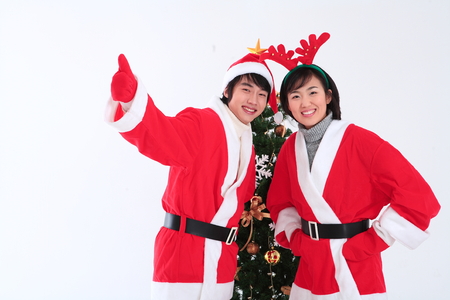 Asian couple with santa outfit - isolated on whiteの写真素材