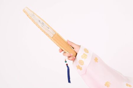 Asian woman with traditional clothing perfoming traditional play - isolated on whiteの写真素材