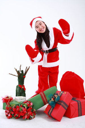 Asian girl with santa outfit and gifts- isolated on whiteの写真素材