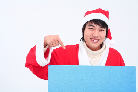 Asian man with santa outfit and gifts- isolated on whiteの写真素材