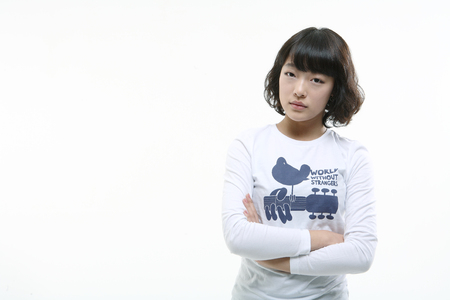 Young asian woman posing in studio - isolated on whiteの写真素材