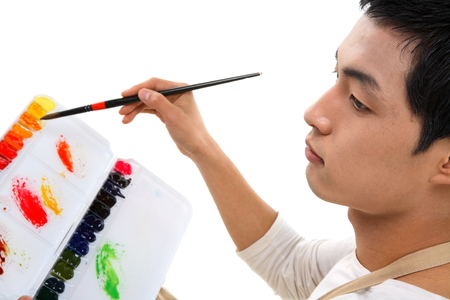 Asian man majoring in art - isolated on whiteの写真素材