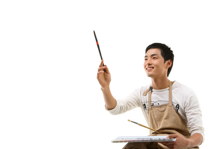 Asian man majoring in art - isolated on whiteの写真素材