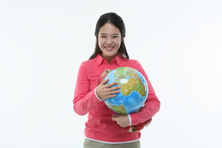 Young asian female college stuent studying - isolated on whiteの写真素材