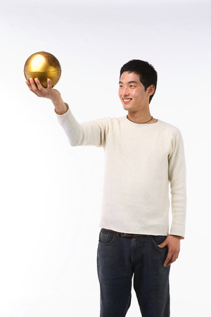 Asian college male student posing in studio - isolated on whiteの写真素材