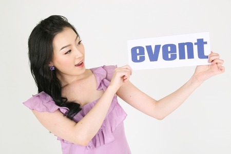 Shopping Concept - Young Asian woman posing with event text card