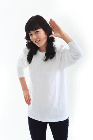 Young asian female student in studio - isolated on whiteの写真素材