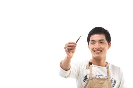 Asian man majoring in art - isolated on whiteの写真素材