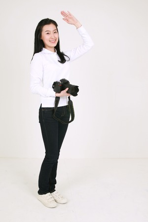 Young asian female student in studio - isolated on whiteのeditorial素材