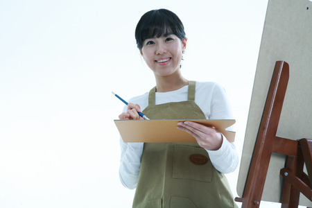 Asian woman majoring in art - isolated on whiteのeditorial素材