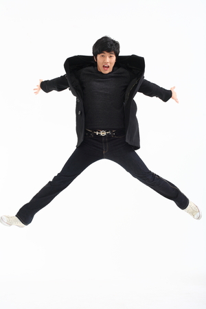 Young asian man posing in studio - isolated on whiteの写真素材