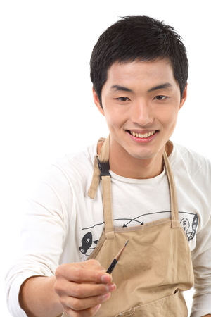 Asian man majoring in art - isolated on whiteの写真素材