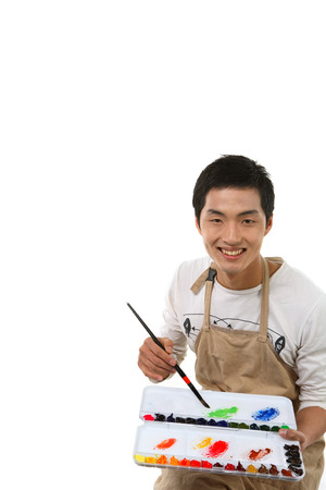 Asian man majoring in art - isolated on whiteの写真素材