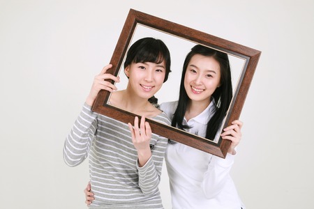 Happy college students in studio - isolated on whiteの写真素材