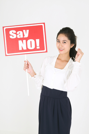 No smoking concept - Young Asian businesswoman holding Say No! signの写真素材