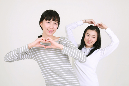 Happy college students in studio - isolated on whiteの写真素材