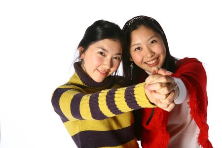 Two asian woman in studio - isolated on whiteの写真素材