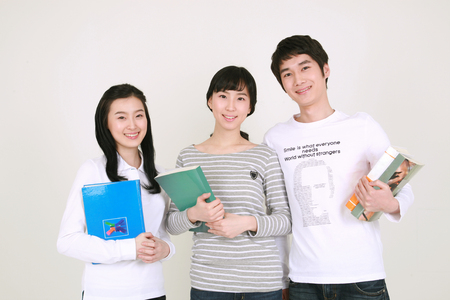 Happy college students in studio - isolated on whiteの写真素材