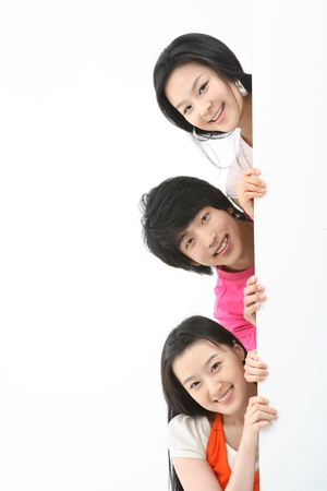 Young college students in studio - isolated on whiteの写真素材