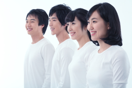 Young college students in studio - isolated on whiteの写真素材