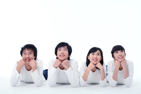 Young college students in studio - isolated on whiteの写真素材