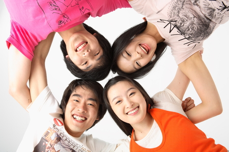 Young college students in studio - isolated on whiteの写真素材