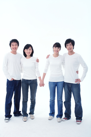 Young college students in studio - isolated on whiteの写真素材