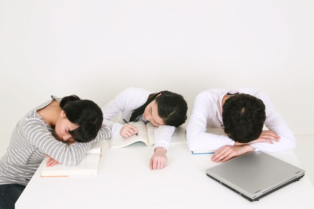 College students in studio - isolated on whiteの写真素材