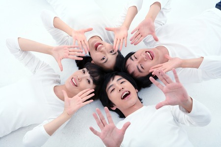 Young college students in studio - isolated on whiteの写真素材