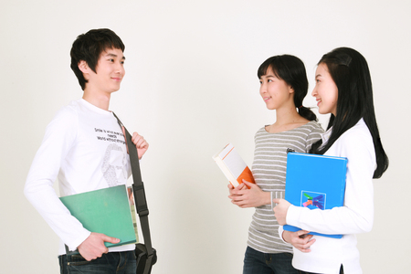 Happy college students in studio - isolated on whiteの写真素材