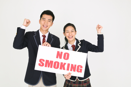 No smoking concept - Asian students in school uniform posing with No smoking signsの写真素材