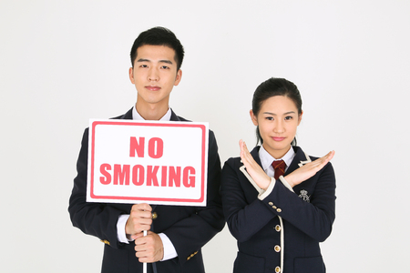 No smoking concept - Asian students in school uniform posing with No smoking signsの写真素材