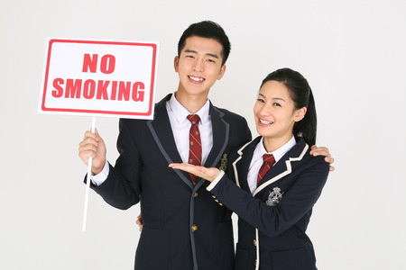 No smoking concept - Asian students in school uniform posing with No smoking signsのeditorial素材