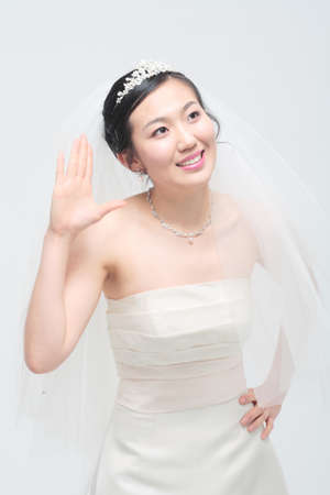 Beautiful Asian bride posing, isolated on whiteの写真素材