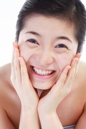 Beauty Concept - Close up shot of Asian woman's face, isolated on whiteの写真素材