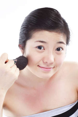 Beauty Concept - Close up shot of Asian woman applying makeup with make up toolsの写真素材