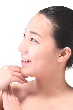 Beauty Concept - Close up shot of Asian woman's fresh skin, isolated on whiteの写真素材