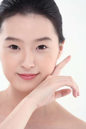 Beauty Concept - Young Asian woman with fresh skin, isolated on whiteの写真素材