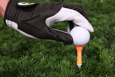 Asian male golfer practicing golf indoorsの写真素材