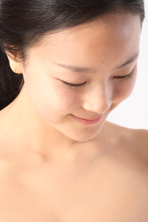 Beauty Concept - Close up shot of Asian woman's face, isolated on whiteの写真素材