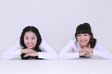 Asian female students posing in the studio - isolated on whiteの写真素材