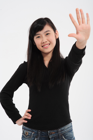 A teenage girl in the studio,isolated on white.の写真素材